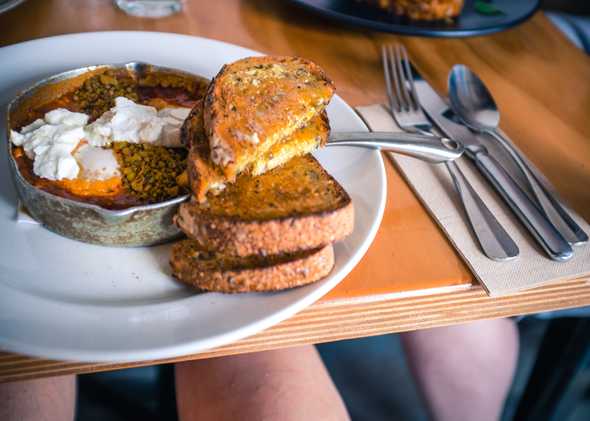 Spicy baked eggs with a dukkah spice blend and toast at Axil